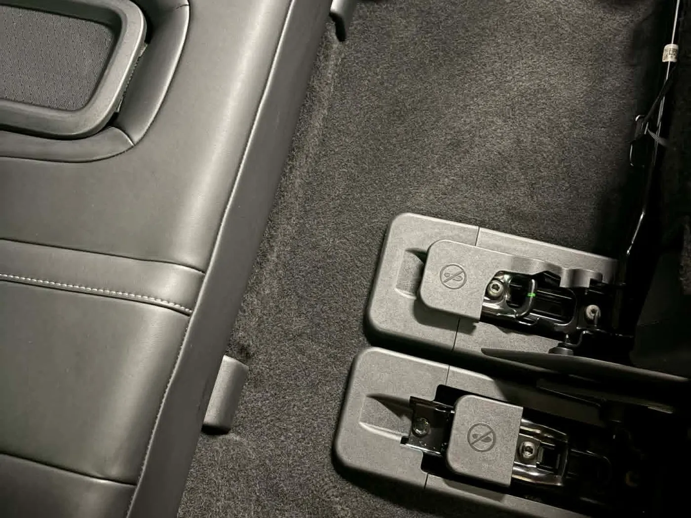 Same rear footwell after detailing: carpet vacuumed clean and seat hardware wiped down